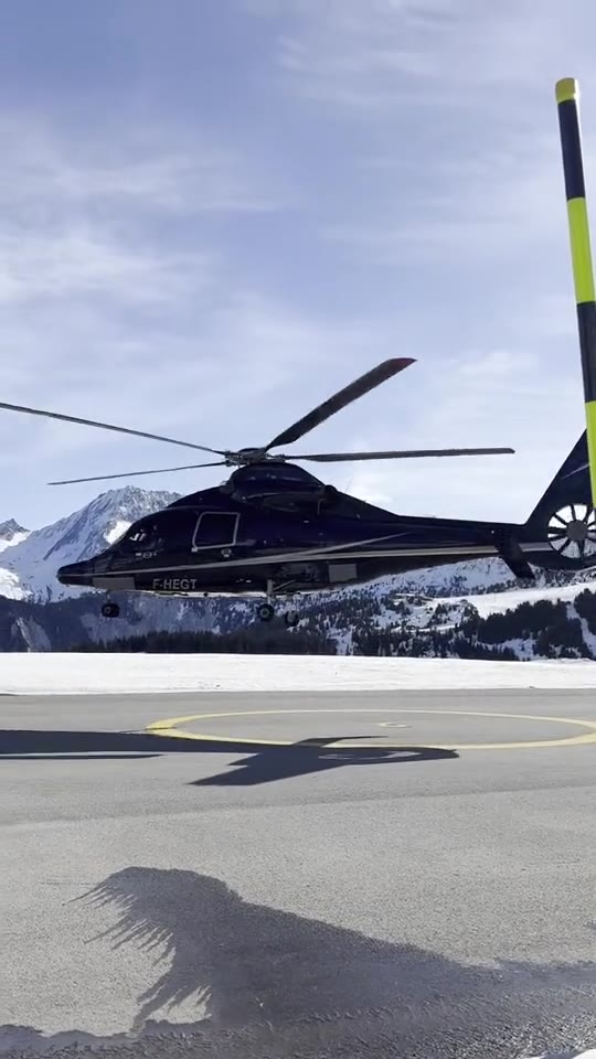A helicopter on the snow at the Courchevel altiport