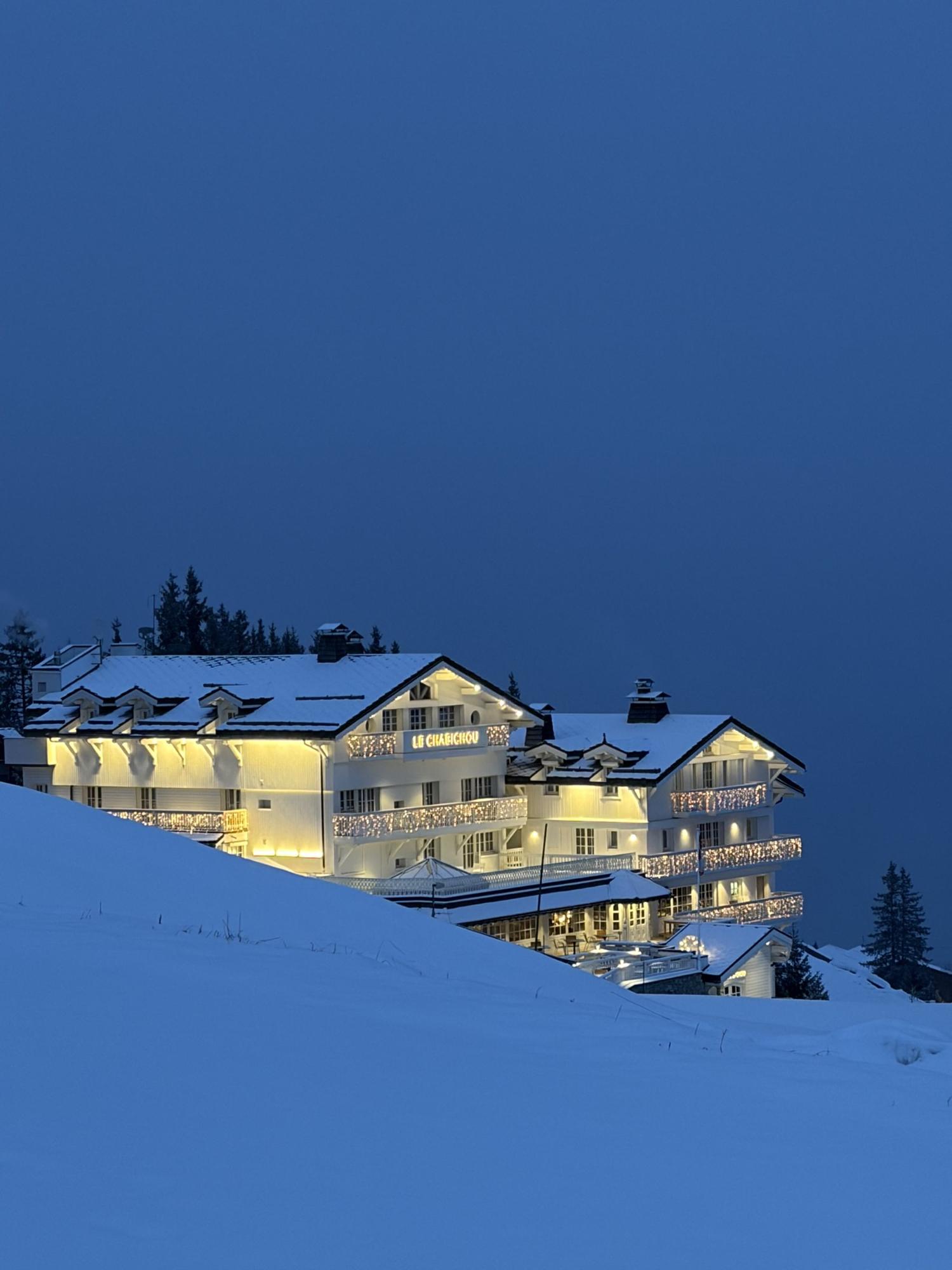 Courchevel lit up at blue hour above the snow